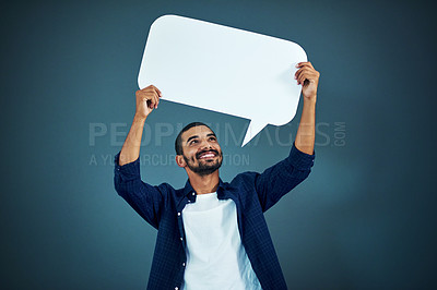 Buy stock photo Studio shot of a handsome young businessman holding up a speech bubble