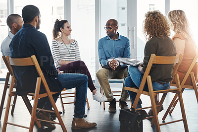 Buy stock photo A group therapy session with diverse people sharing their sad problems and stories. People sitting in a circle talking about their mental health issues and looking for support, help and counseling
