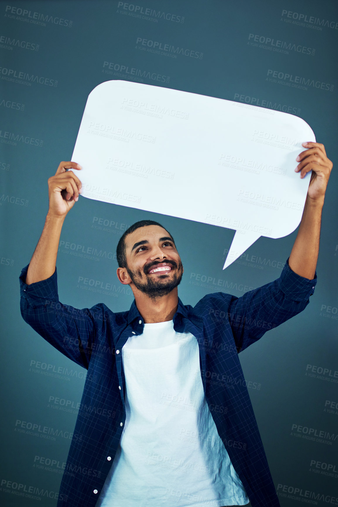Buy stock photo Studio shot of a man holding a speech bubble against a gray background