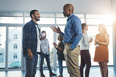Buy stock photo Creative men talking at networking event, sharing startup ideas and discussing new innovation at business conference. Diverse group of people meeting, collaborating or having a conversation in office
