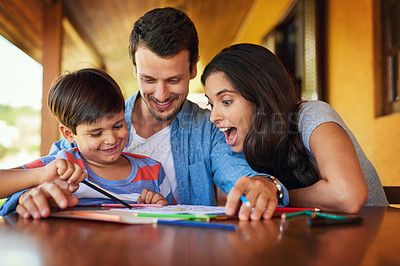 Buy stock photo Shot of a couple and their son coloring in together outdoors
