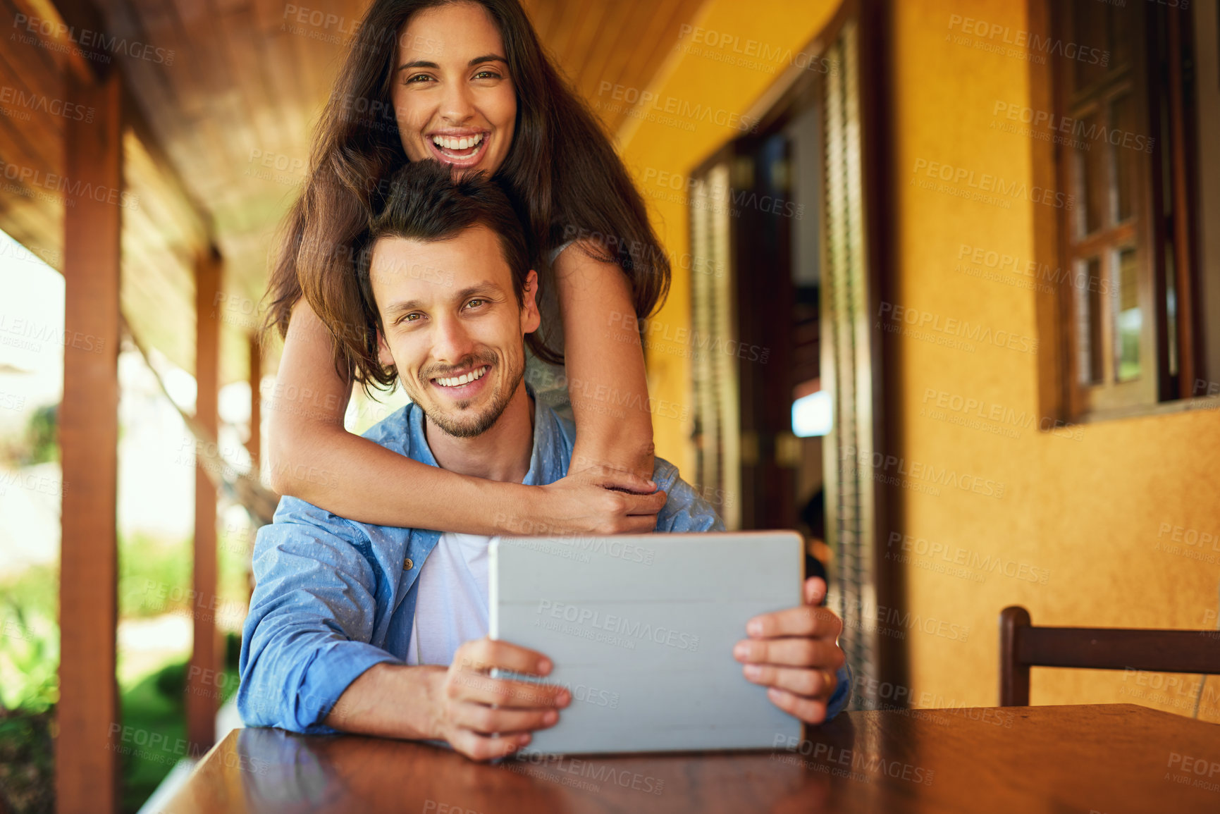 Buy stock photo Portrait of a young couple using a digital tablet together outdoors