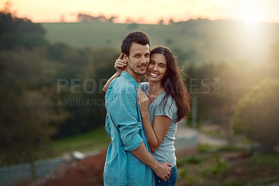 Buy stock photo Cropped portrait of an affectionate young couple sharing a loving moment while standing outdoors