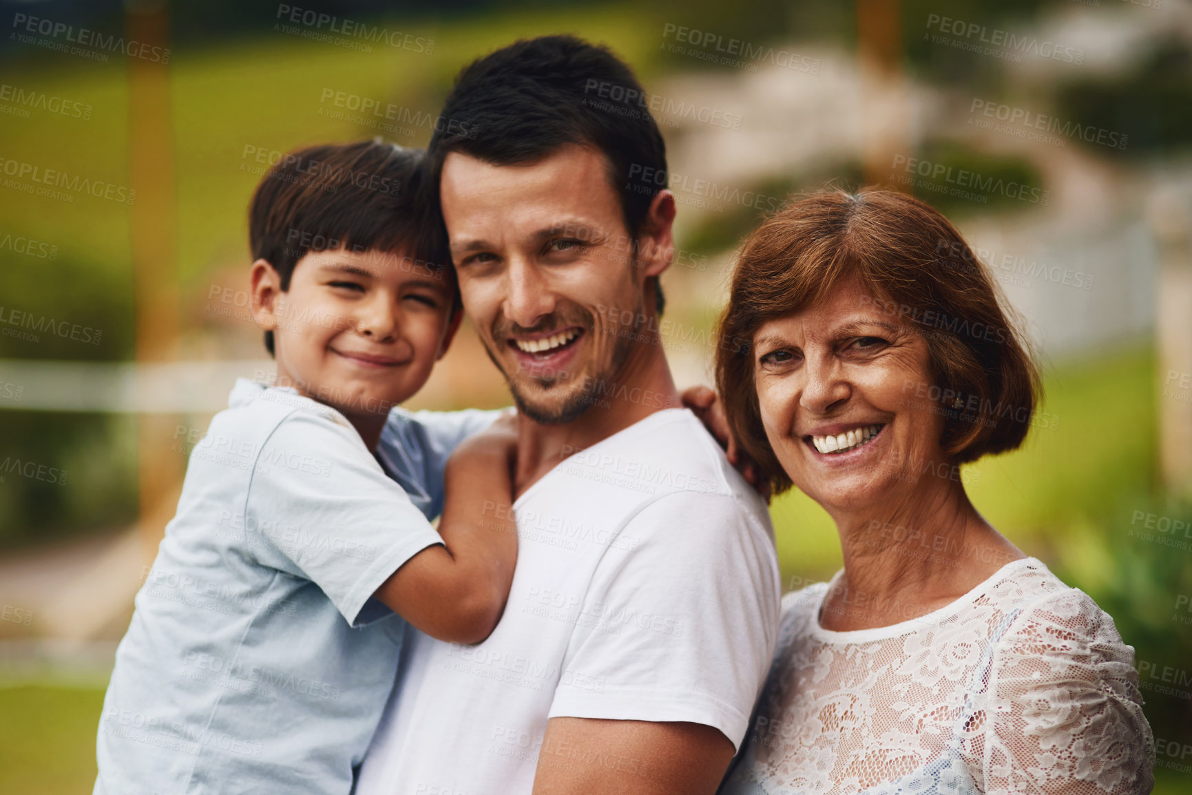 Buy stock photo Portrait of a young man spending time with his mother and son at the park