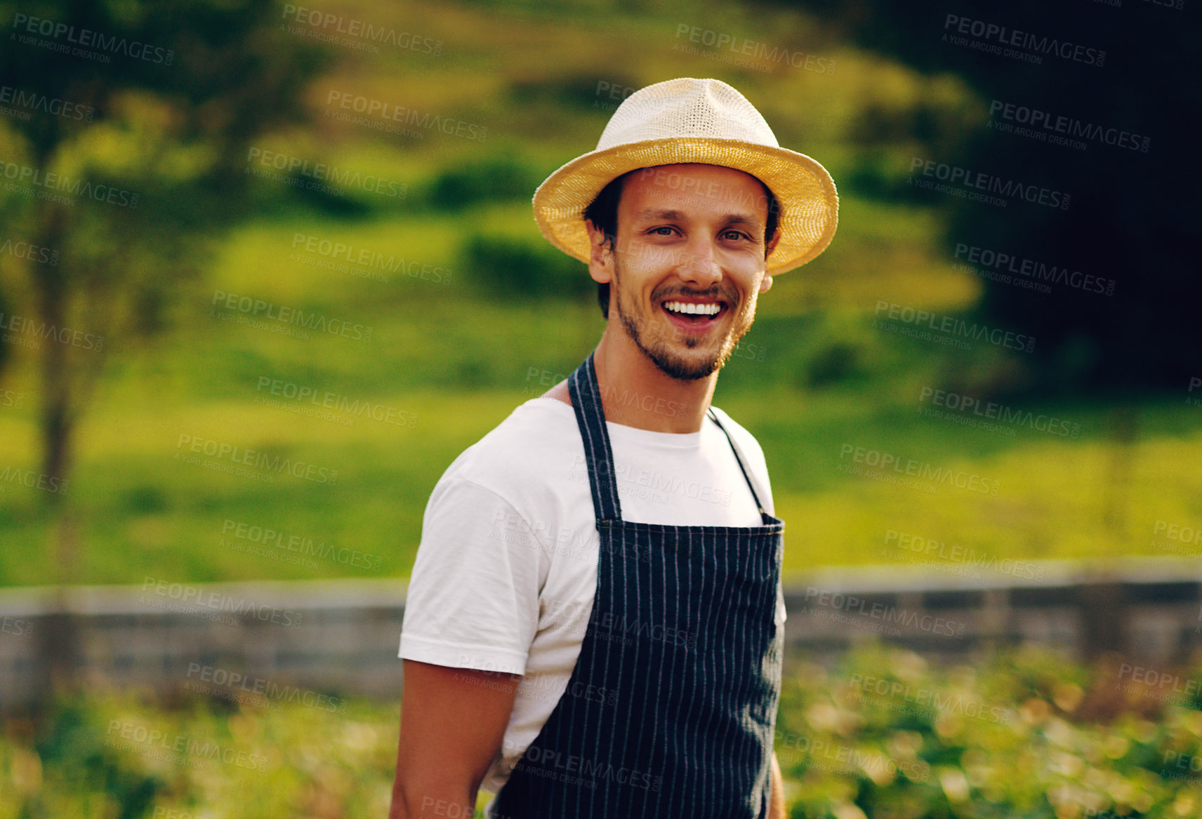 Buy stock photo Portrait of a handsome young man working in a garden