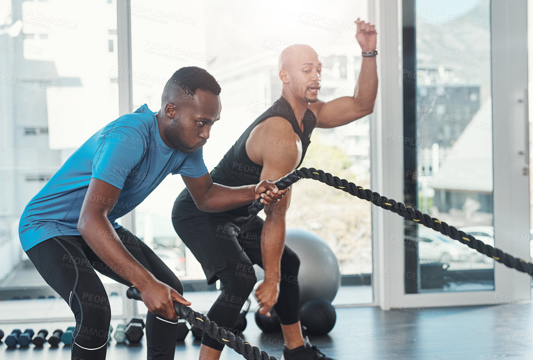 Buy stock photo Coach, man and rope for fitness in gym for workout, training and resilience for healthy lifestyle. Sports, black people and exercise to target muscle, arms and shoulders with balance for strength