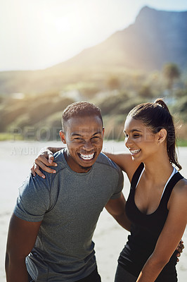 Buy stock photo Shot of a sporty young couple exercising at the beach