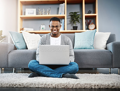 Buy stock photo Computer, floor and portrait of man in home, online research and typing in living room for work or career opportunity. Happy, carpet and young african person working on laptop or technology in lounge