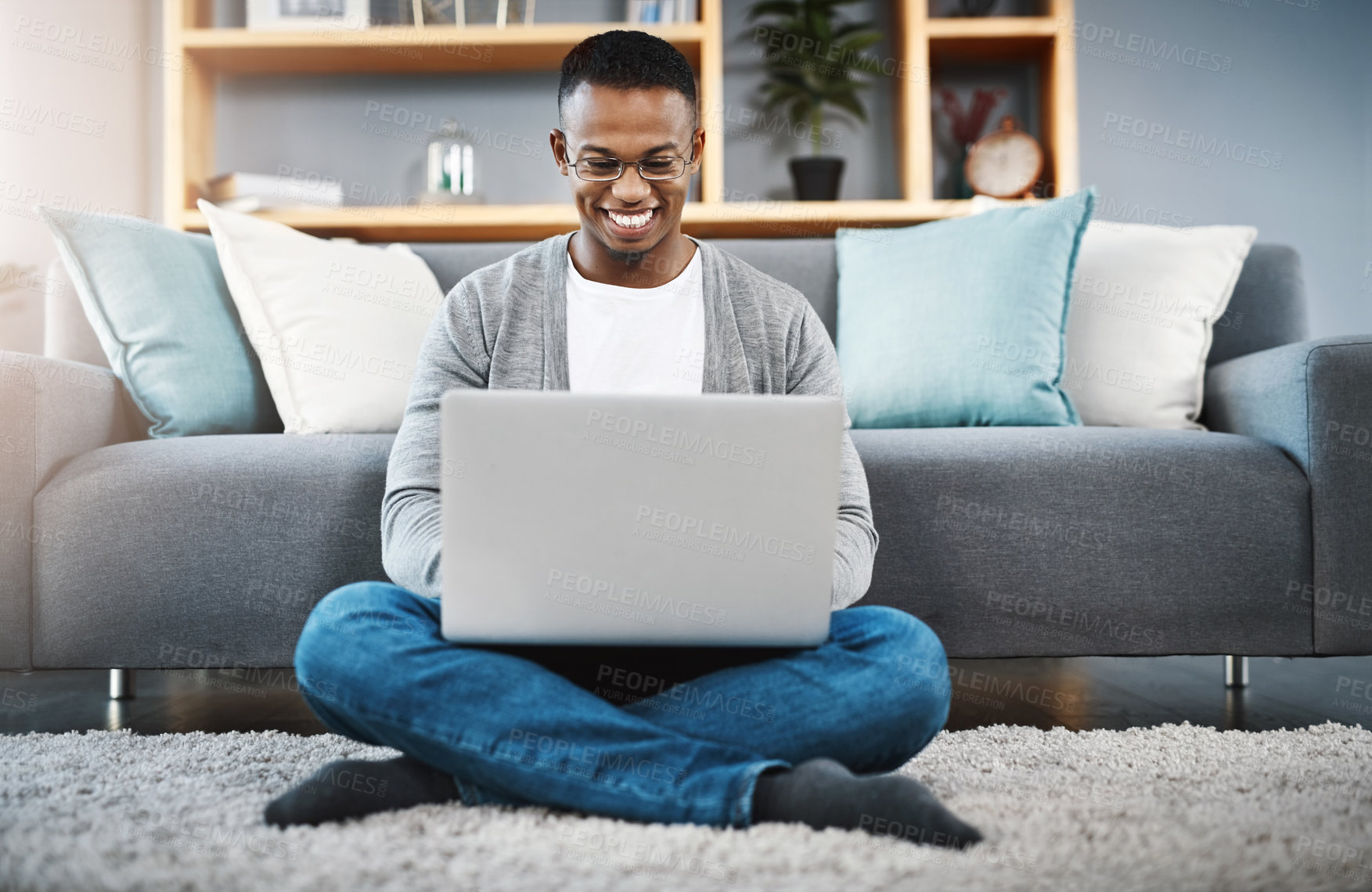 Buy stock photo Laptop, floor and happy man with work from home, online research and typing in living room for career opportunity. Relax, carpet and young african person working on computer or technology in lounge