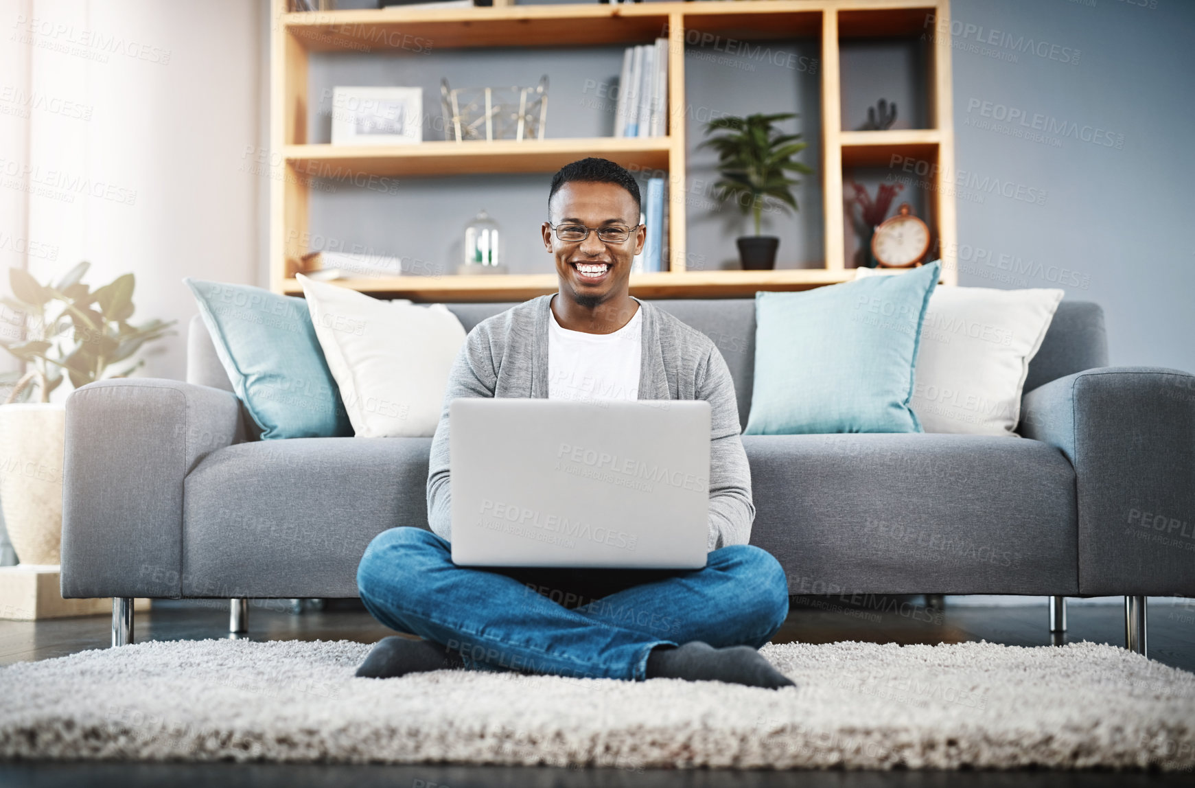 Buy stock photo Floor, laptop and portrait of man for home, online research and happy freelancer job in living room with remote work opportunity. Smile, carpet and young african person on computer or technology 