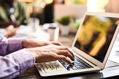 Buy stock photo Closeup shot of an unrecognizable businessman working on a laptop at a cafe