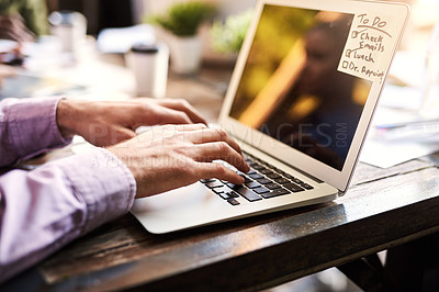 Buy stock photo Closeup shot of an unrecognizable businessman working on a laptop at a cafe