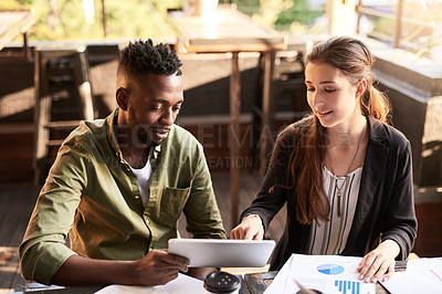 Buy stock photo Shot of two designers having a meeting at a coffee shop