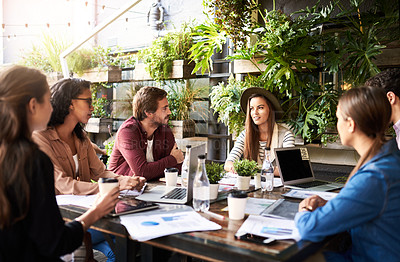 Buy stock photo Shot of a group of designers having a meeting at a coffee shop