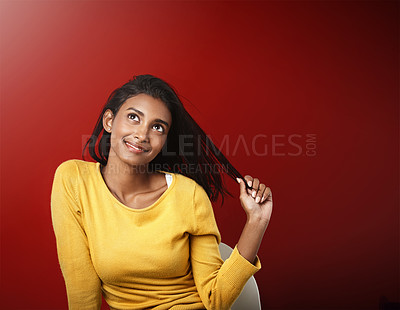 Buy stock photo Studio, thinking and happy woman with casual fashion, relax and positive attitude of female person on mockup space. Smile, ideas and gen z girl with cool style, confidence and pride on red background