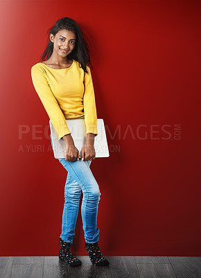 Buy stock photo Student woman, portrait and laptop by wall with smile for learning, education or research for development. Gen z gIrl, computer and happy for study, elearning and social network app by red background