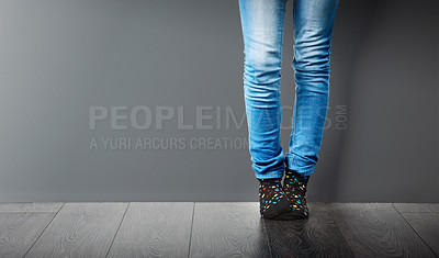 Buy stock photo Socks, jeans and legs of person in studio with stylish clothes on wall, mockup space or grey background. Trendy, edgy and fashionista in modern outfit, design or denim with pants on ground and floor