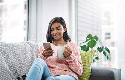 Buy stock photo Relax, coffee and girl on sofa with phone for social media, networking or streaming on weekend. Smile, connect and woman on couch with smartphone for communication, online chat or search in apartment