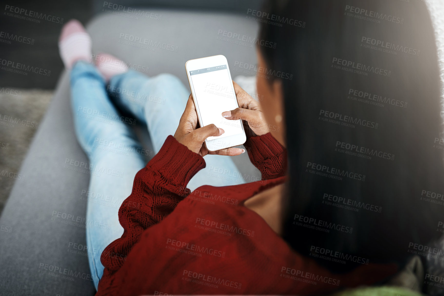 Buy stock photo Rear view, female influencer and cellphone on sofa for relax, social media and streaming online in home for weekend. Young person or teenager with tech for scrolling or browsing on app for break