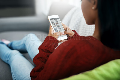 Buy stock photo Home, connection and woman with a cellphone, living room or typing for social media, scroll or relax. Female person, mobile app or girl on a couch, search website or online reading with smartphone