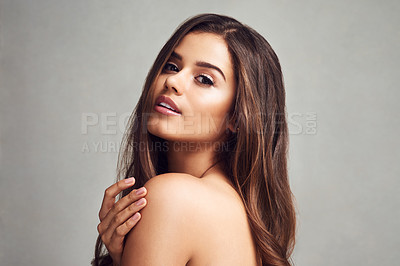 Buy stock photo Studio shot of a young beautiful woman with long gorgeous hair posing against a grey background