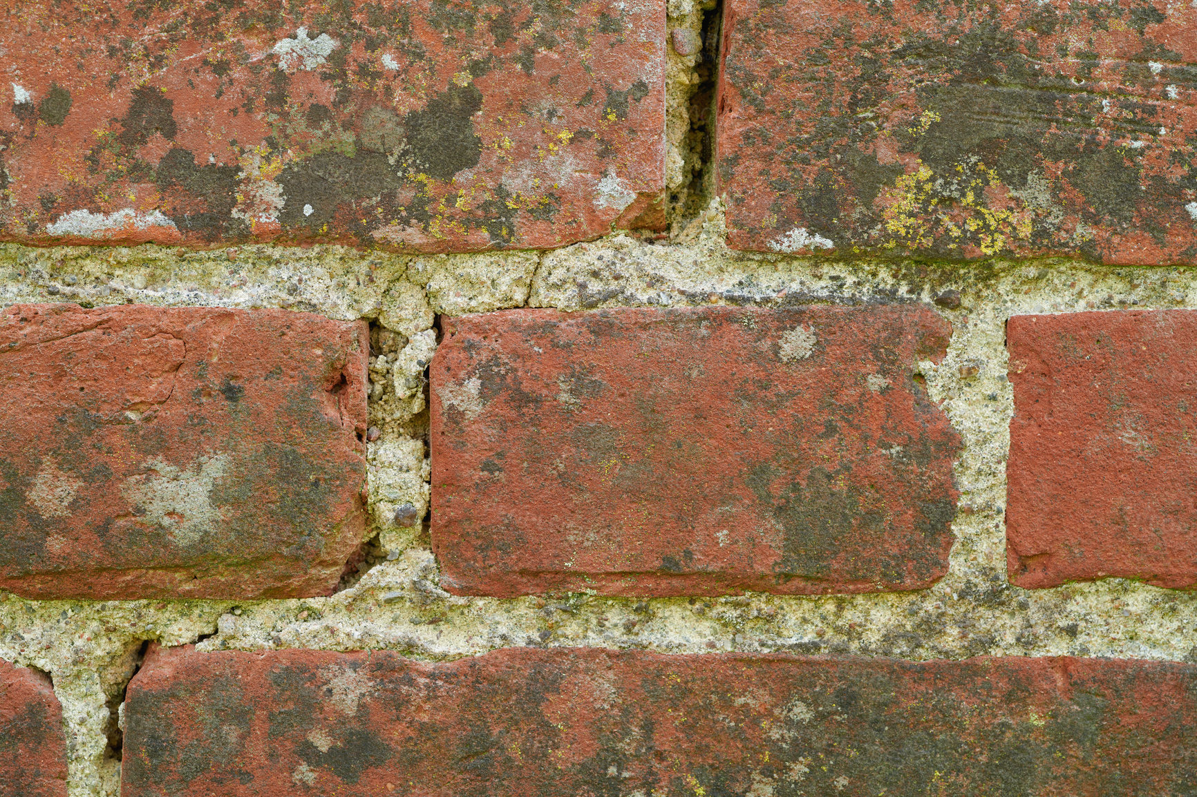 Buy stock photo Closeup of a dirty red brick wall with copy space. Weathered exterior surface of a house. Rough surface texture of building blocks with concrete cement layers for construction of a solid structure. 