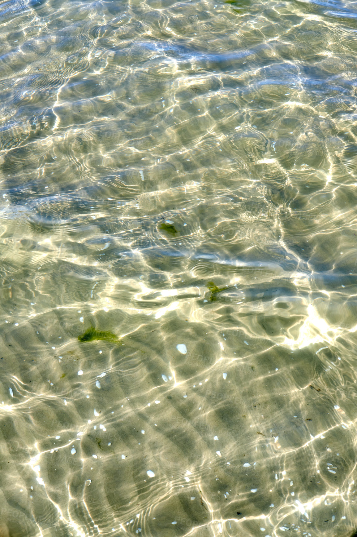 Buy stock photo Above view of sunlight reflecting on water at beach. Closeup of shallow waves and calm ripples on coastline on sunny day outside. Clear liquid refracting sun rays in summer for copy space background