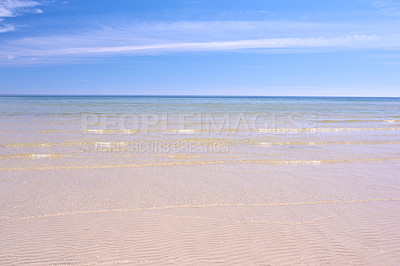 Buy stock photo Copy space at the beach with a blue sky background above the horizon. Calm ocean waves across an empty sea along the shore. Peaceful and tranquil landscape for a relaxing and zen summer getaway 
