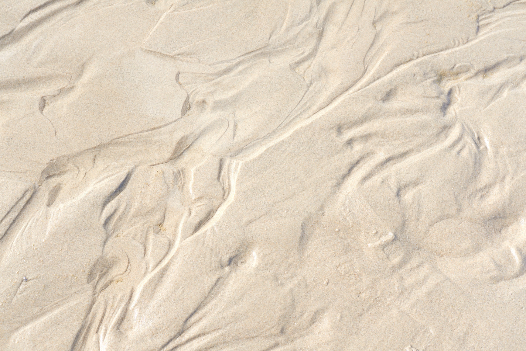 Buy stock photo Abstract white sand sediment pattern, seaside natural organic landscape shining in the sun. Top view of a conceptual textured image of moist sea sand formed at the sea shore on a summer vacation.