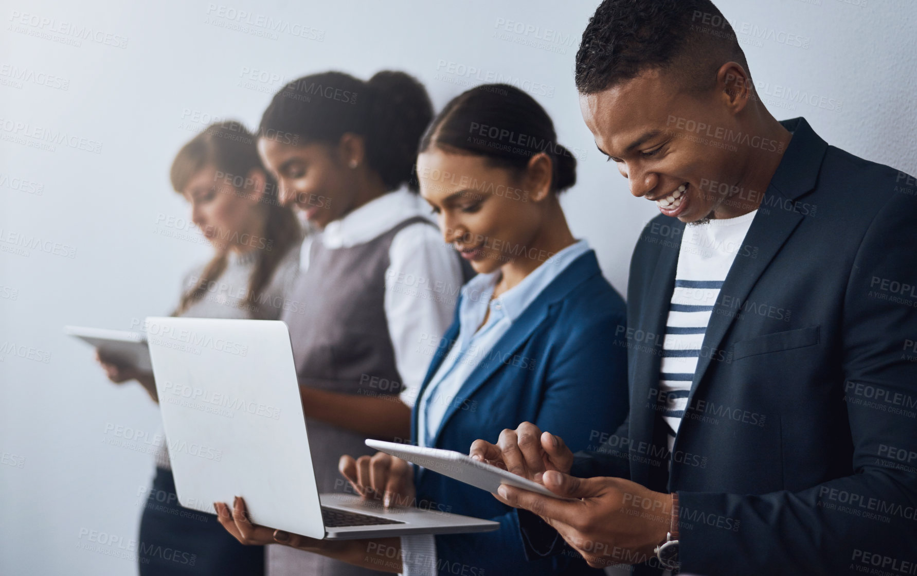 Buy stock photo Cropped shot of a group of young businesspeople waiting in line for their interviews