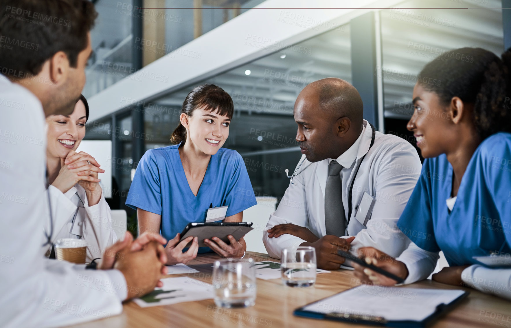 Buy stock photo Tablet, discussion and team of doctors in hospital with planning for medical treatment in collaboration. Technology, meeting and group of healthcare workers with research for surgery in clinic.