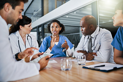 Buy stock photo Shot of a group of doctors having a meeting in a hospital