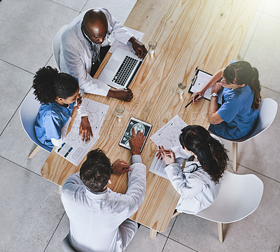 Buy stock photo Shot of a group of doctors having a meeting in a hospital