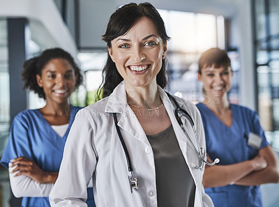 Buy stock photo Portrait of a team of confident doctors standing together in a hospital