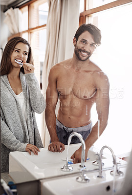 Buy stock photo Couple, bathroom and brushing teeth in mirror for gums, morning and toothbrush for treatment. People, cosmetics and reflection in home for tooth whitening, together and grooming for dental healthcare