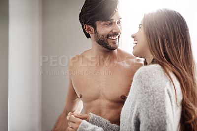 Buy stock photo Shot of a happy young couple taking a pregnancy test at home