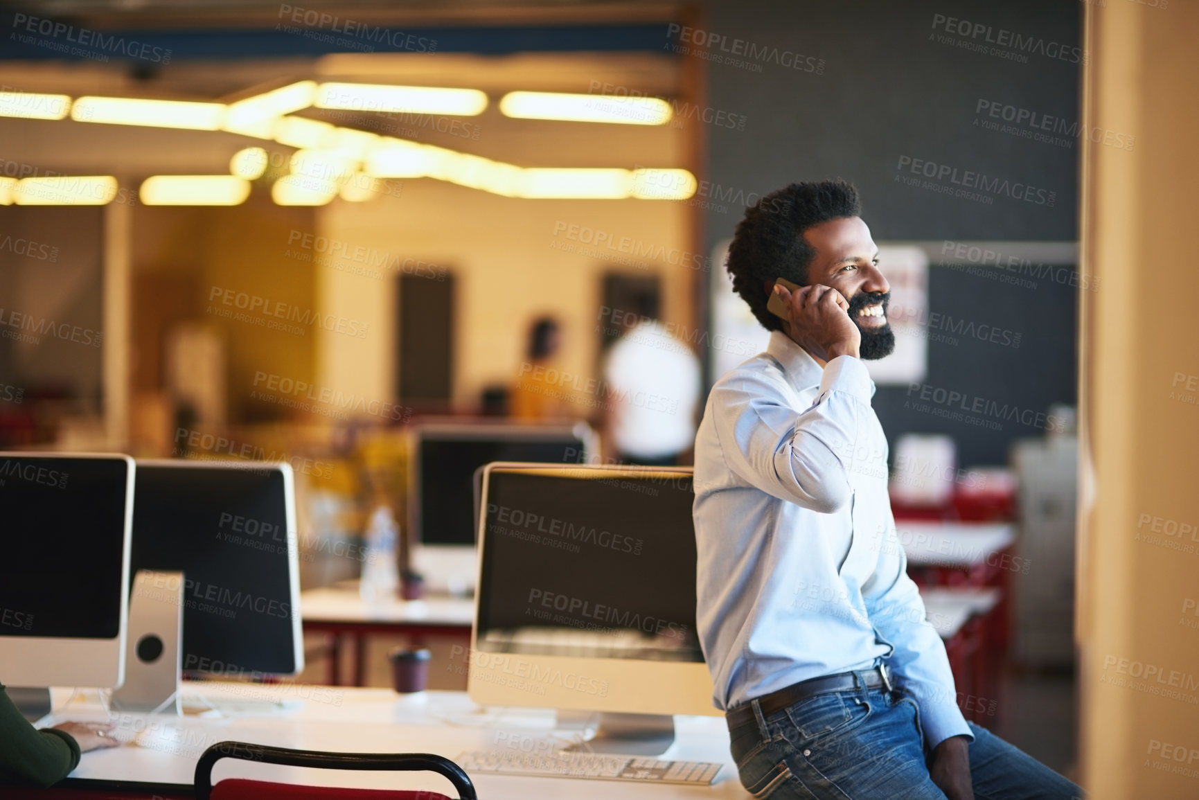 Buy stock photo Shot of a confident businessman talking on his cellphone while standing in an modern office