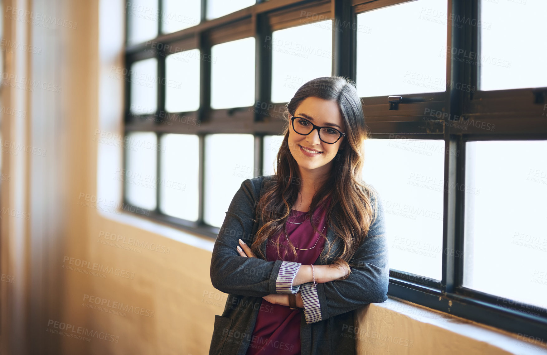 Buy stock photo Portrait of a confident young businesswoman working in a modern office