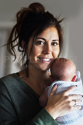 Buy stock photo Portrait of a cheerful young woman holding her little infant son at home during the day