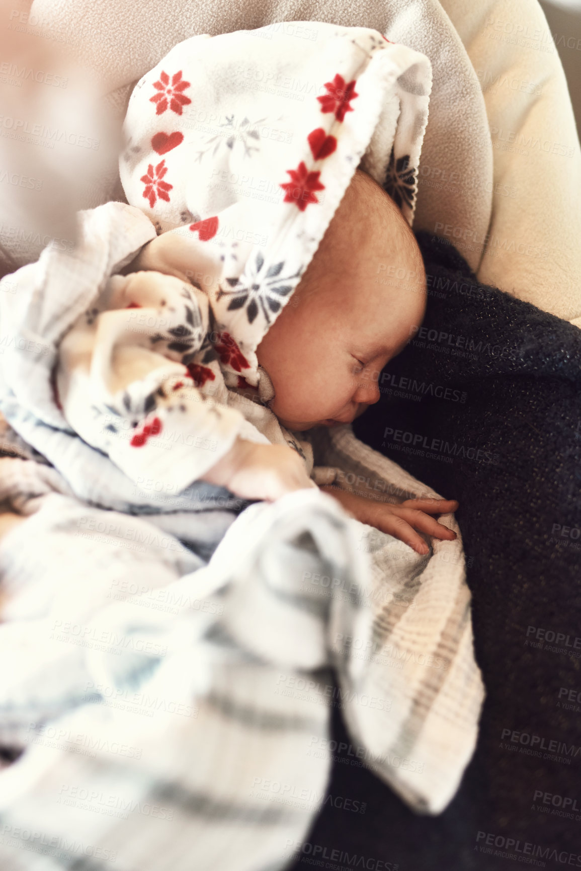 Buy stock photo High angle shot of a tired little infant child sleeping on his mother's chest while being covered in blankets at home during the day