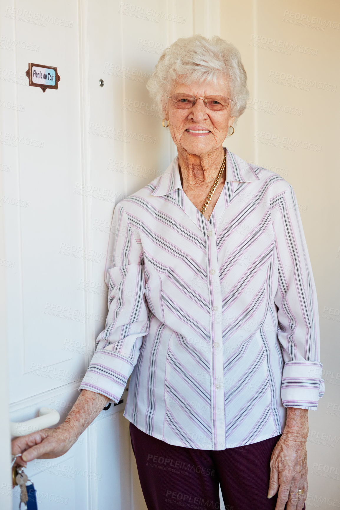 Buy stock photo Senior woman, portrait and door in retirement home with glasses for peace, health and positive mood. Elderly person, face and happy in nursing house with keys for wellbeing, calm and gratitude