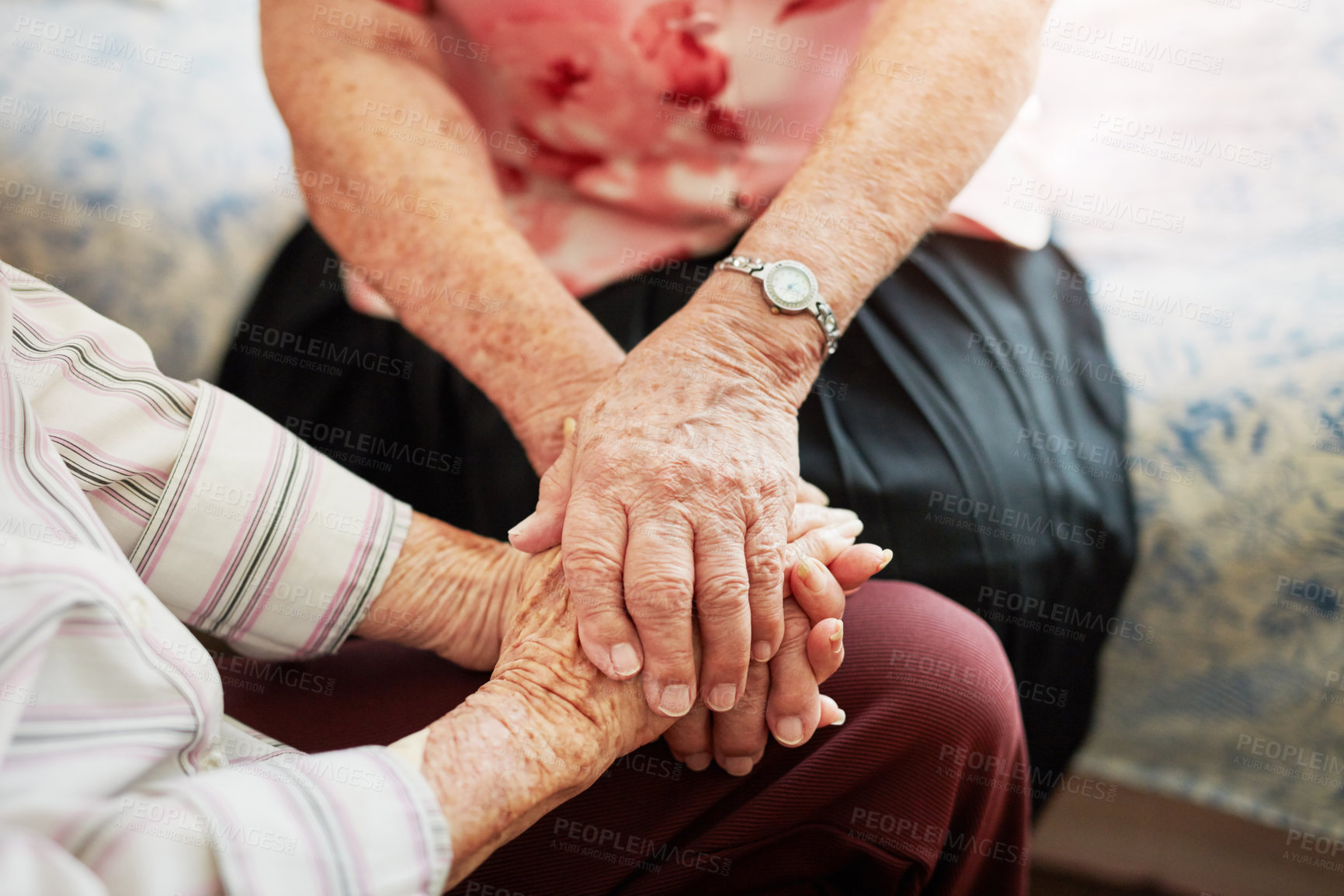 Buy stock photo Cropped shot of two senior women holding hands in a retirement home