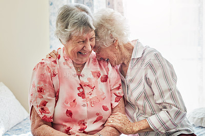 Buy stock photo Happy, funny and senior woman friends laughing in the bedroom of a retirement home together. Smile, comedy and laughter with an elderly female pensioner and friend bonding indoor during a visit