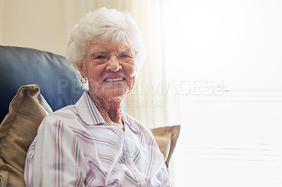 Buy stock photo Portrait of a happy elderly woman relaxing on a chair at home