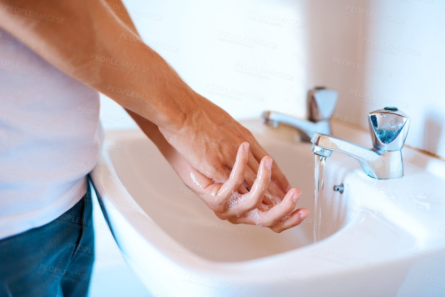 Buy stock photo Closeup shot of an unrecognizable man washing his hands at a basin