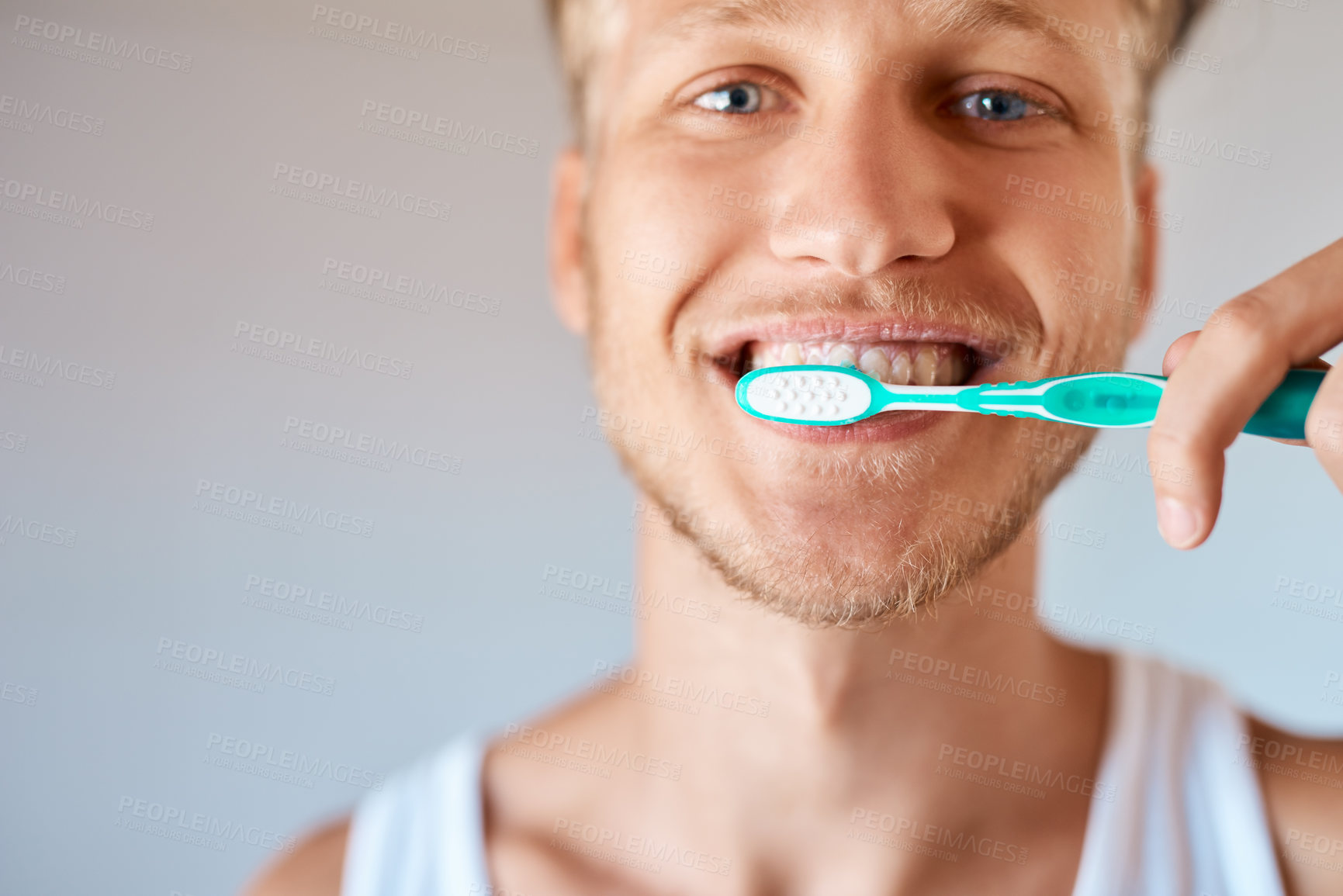 Buy stock photo Dental, portrait and man with toothbrush in bathroom for oral hygiene, wellness or brushing teeth. Mouth, hand and male person with smile for self care, remove plaque or morning routine in home