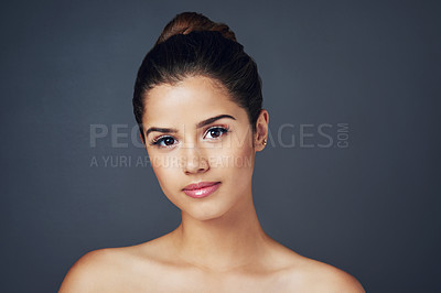 Buy stock photo Studio shot of a beautiful young woman with flawless skin posing against a blue background