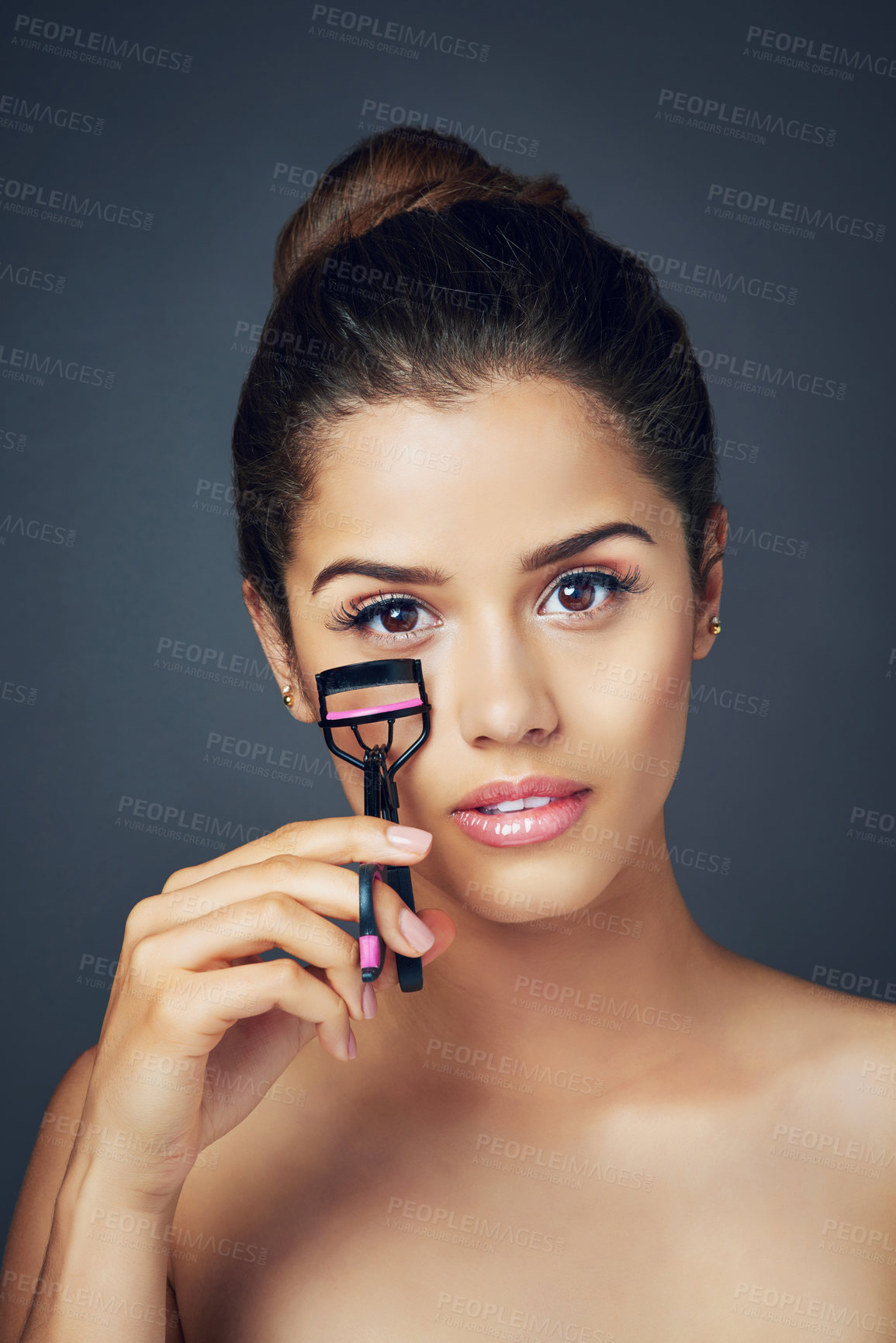 Buy stock photo Beauty, eyelash curler and portrait of woman in studio for cosmetics, glamour and grooming. Salon, spa and face of isolated person with tools for makeup, lashes and application on gray background