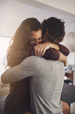Buy stock photo Woman, man and hug in home for love, care and quality time together with commitment to relationship. Happy young couple, hugging and romance of lovers, smile and relax with trust of partner in house
