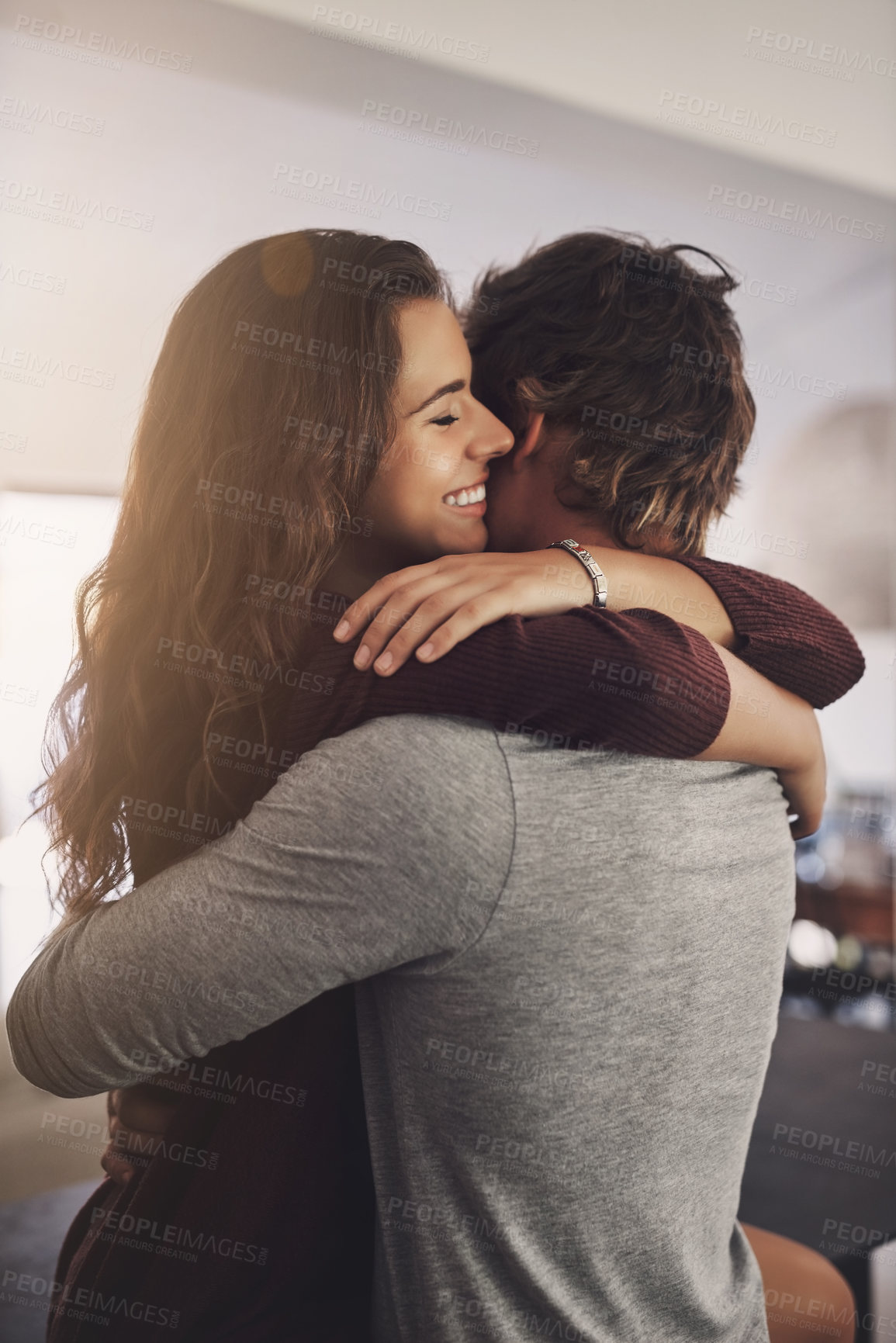 Buy stock photo Happy woman, man and hug in home for love, care and quality time together with commitment to relationship. Young couple, hugging and anniversary of lovers, smile and happiness of loyalty to partner